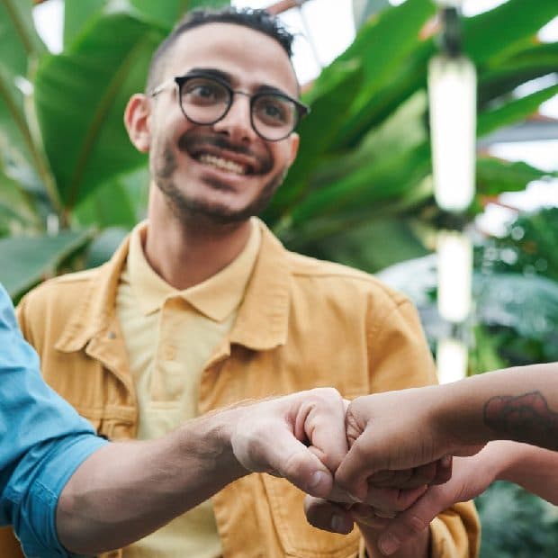 Two people fist-bumping